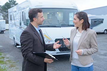 Man and woman talking about RV prices
